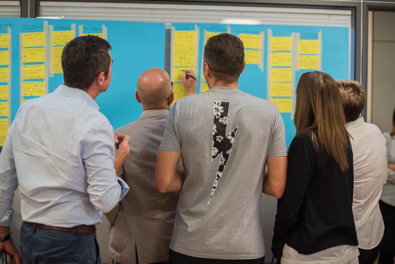 A team mapping ideas on a wall of notes