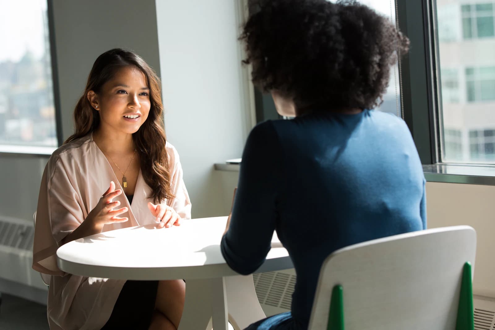 Two people in conversation at a table